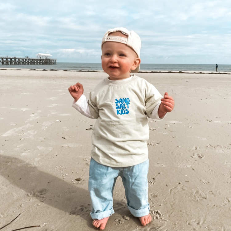 Boy toddler on beach in swell day surf tshirt 