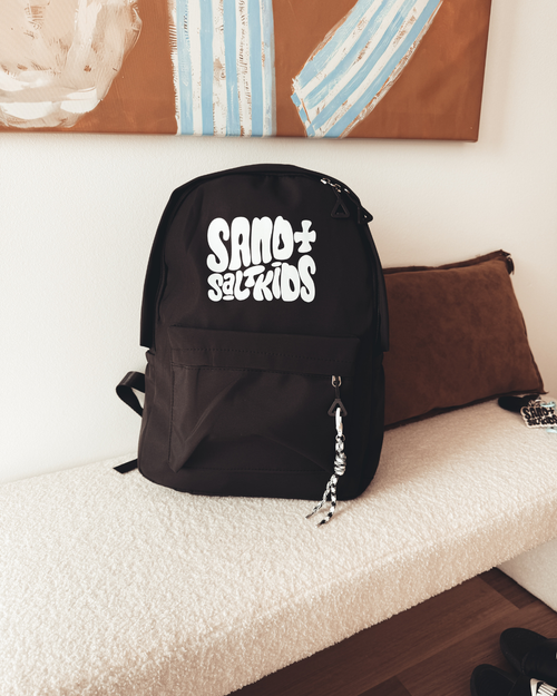 Black kids backpack with Sand + Salt Kids logo, multiple pockets and rope keychain detail