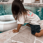 Child wearing grey waffle shorts with surf tee, durable and comfy